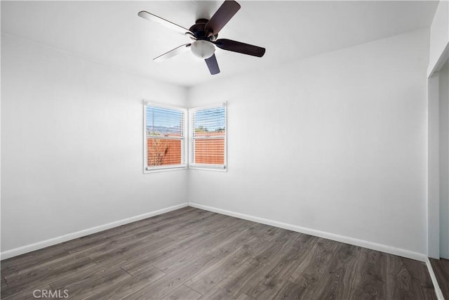 spare room with a ceiling fan, baseboards, and wood finished floors