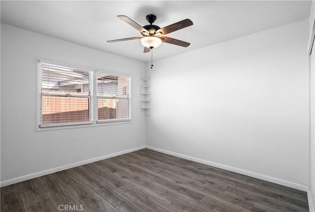 unfurnished room featuring ceiling fan, baseboards, and dark wood-type flooring