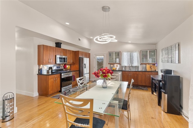19309 Tillman Ave, Carson, CA 90746 - dining area featuring a chandelier, light wood-style flooring, vaulted ceiling, and recessed lighting