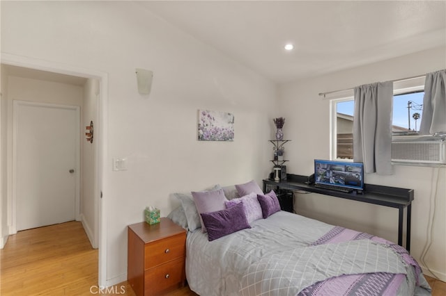 bedroom featuring cooling unit and wood finished floors