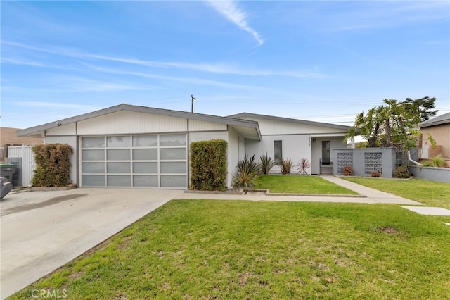 view of front of property with an attached garage, driveway, a front lawn, and fence