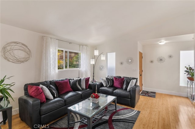 living area featuring light wood-style flooring and baseboards