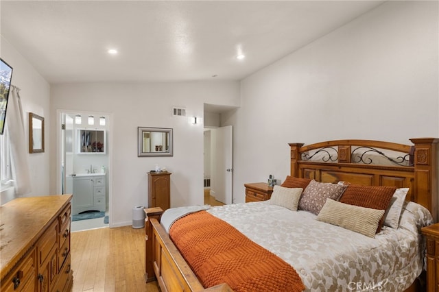 bedroom featuring vaulted ceiling, light wood-type flooring, visible vents, and recessed lighting