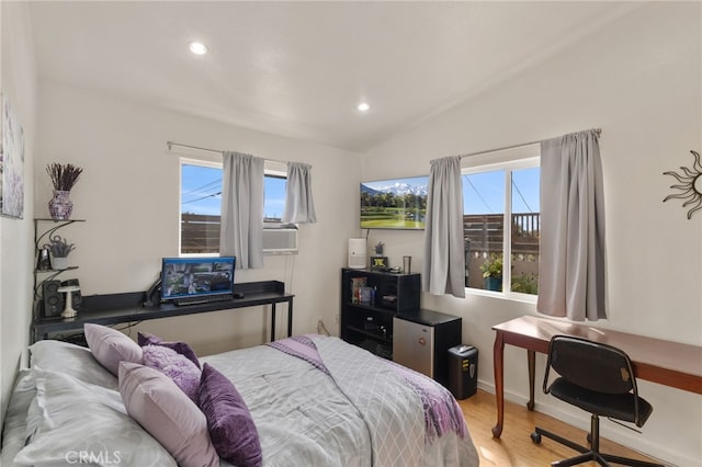 bedroom with recessed lighting, vaulted ceiling, and wood finished floors