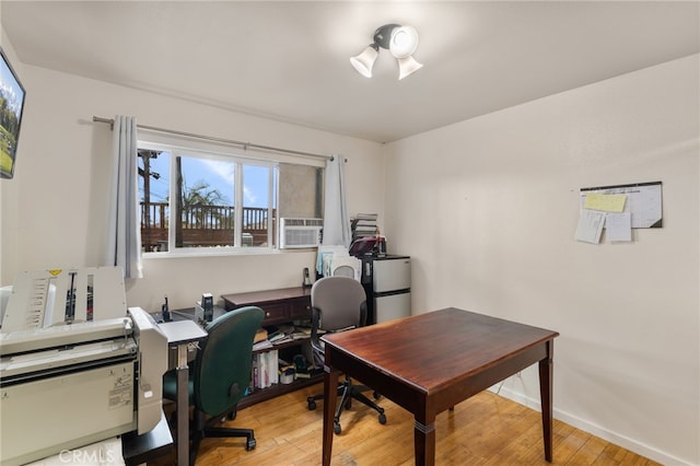 office featuring cooling unit, hardwood / wood-style flooring, and baseboards