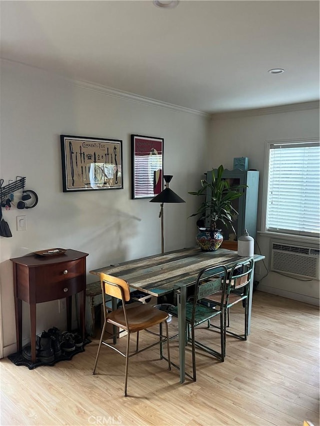 dining space featuring light wood-type flooring, cooling unit, and crown molding