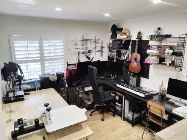 office space with ornamental molding and wood finished floors