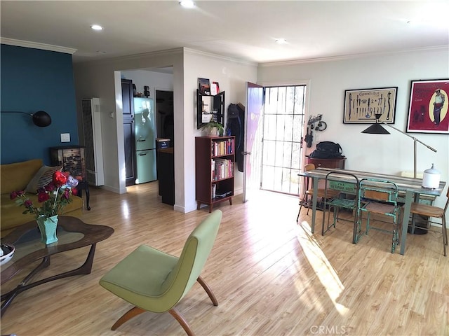 living room featuring recessed lighting, light wood-style floors, baseboards, and ornamental molding