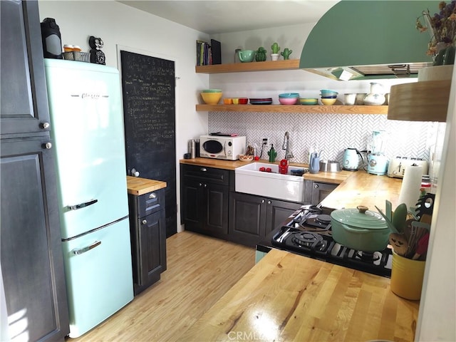 5001 Stoney Creek Rd Unit 356, Culver City, CA 90230 - kitchen featuring refrigerator, butcher block counters, open shelves, light wood-type flooring, and tasteful backsplash