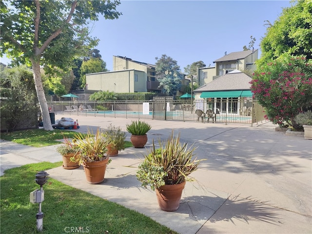 5001 Stoney Creek Rd Unit 356, Culver City, CA 90230 - view of property's community with a pool, a residential view, and a patio