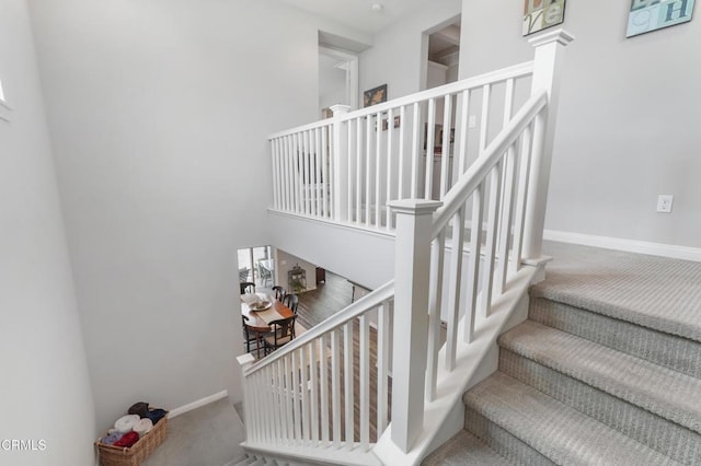 stairs featuring carpet floors and baseboards