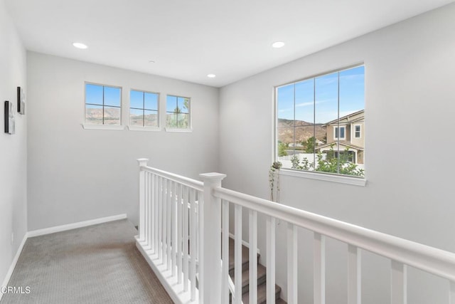 hallway featuring recessed lighting, carpet, an upstairs landing, and a healthy amount of sunlight