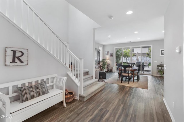 interior space with stairs, recessed lighting, baseboards, and wood finished floors