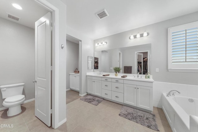 bathroom featuring a closet, visible vents, a sink, and double vanity