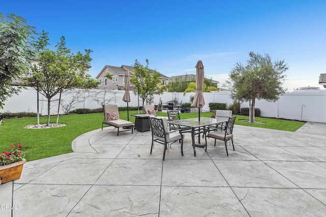 view of patio with a fenced backyard and outdoor dining area