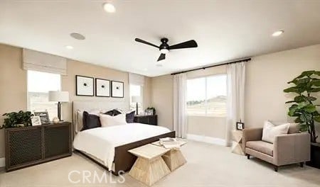 bedroom featuring light carpet, multiple windows, a ceiling fan, and recessed lighting