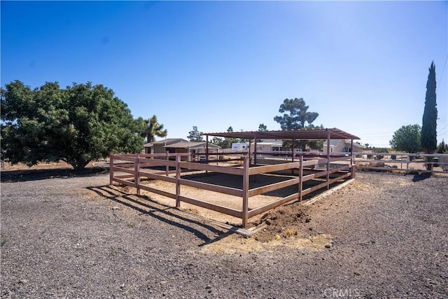 view of horse barn featuring a rural view