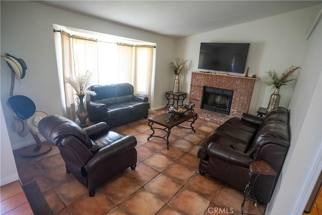 living room with dark tile patterned flooring, a brick fireplace, vaulted ceiling, and baseboards