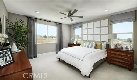 bedroom with light carpet, ceiling fan, and baseboards