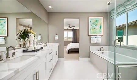 full bath featuring a garden tub, a sink, and double vanity