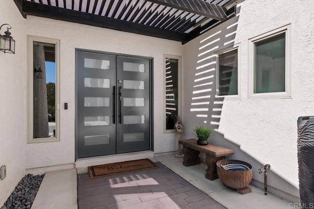 entrance to property with french doors and stucco siding