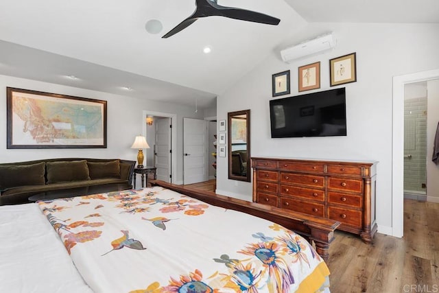 bedroom featuring light wood-style flooring, a ceiling fan, baseboards, vaulted ceiling, and a wall mounted air conditioner