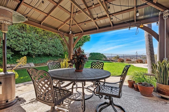 view of patio / terrace with a gazebo, outdoor dining space, and fence