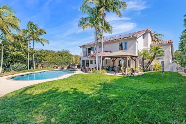 back of house with a patio, stucco siding, a lawn, a gazebo, and a balcony