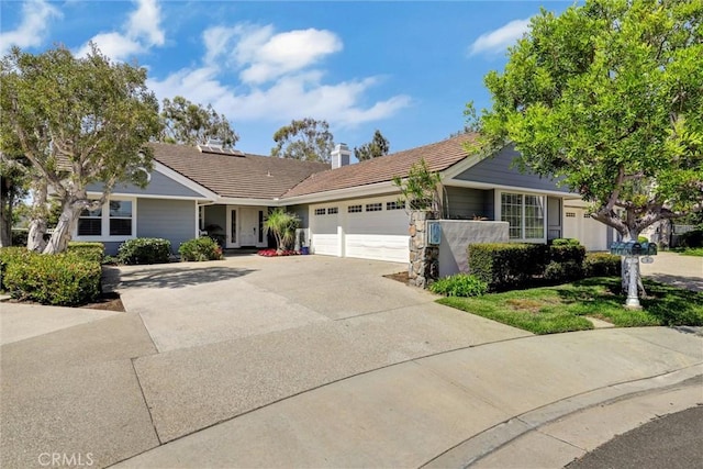 single story home featuring an attached garage, a tile roof, a chimney, and concrete driveway