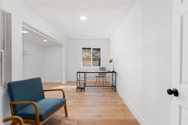 living area with light wood-type flooring, baseboards, and recessed lighting