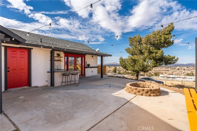 view of patio featuring a fire pit and outdoor dry bar