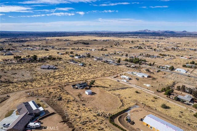 drone / aerial view with a mountain view, a desert view, and a rural view