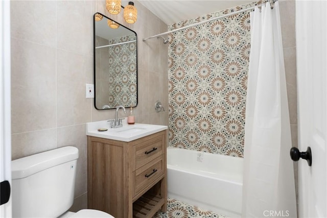 full bathroom with toilet, vanity, shower / bath combo with shower curtain, and tile walls