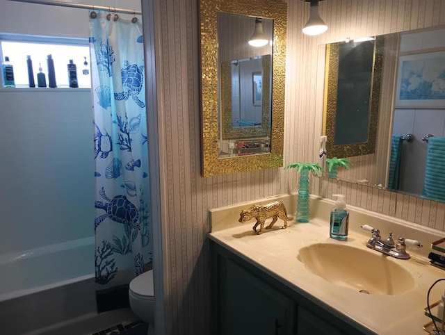 full bathroom with vanity, shower / bathtub combination with curtain, toilet, and wallpapered walls