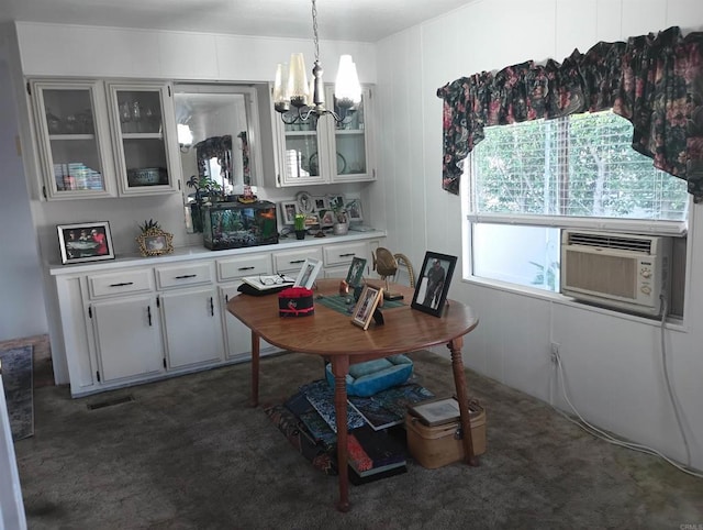 dining space with visible vents, a chandelier, dark colored carpet, and cooling unit