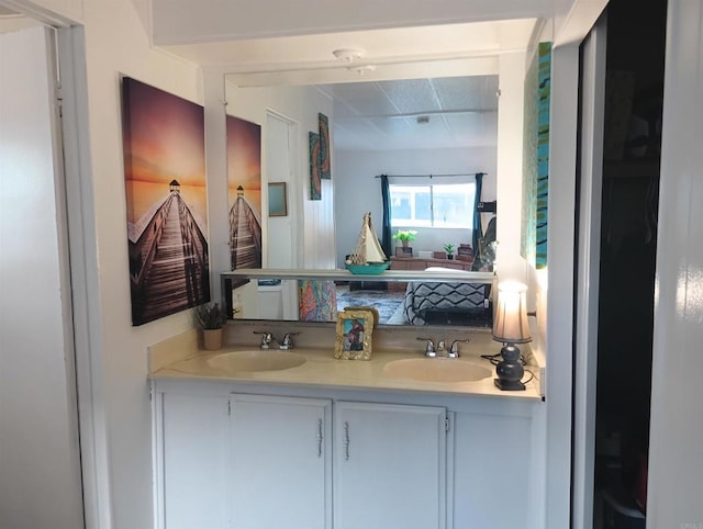 bathroom featuring a sink, ensuite bath, and double vanity