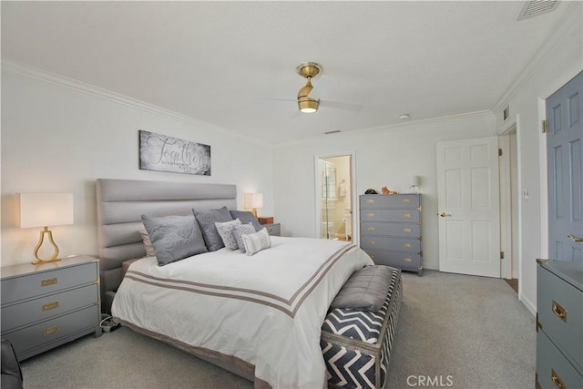 bedroom featuring connected bathroom, visible vents, crown molding, and light colored carpet