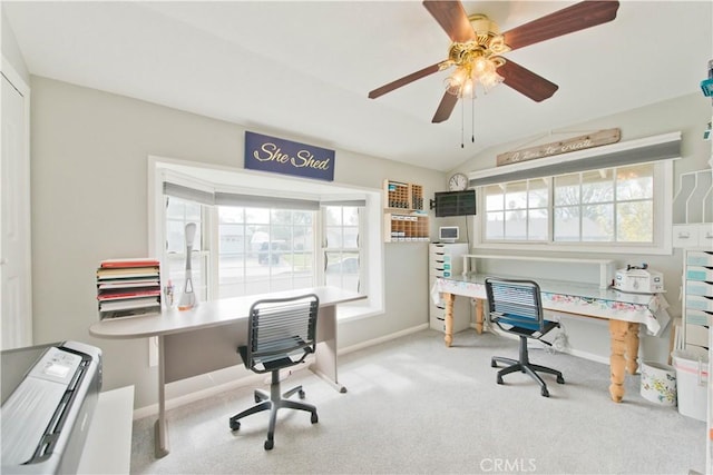 home office with lofted ceiling, light carpet, ceiling fan, and baseboards