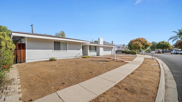 ranch-style home with fence