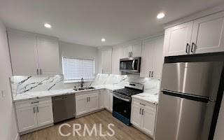 kitchen with white cabinetry, appliances with stainless steel finishes, and a sink