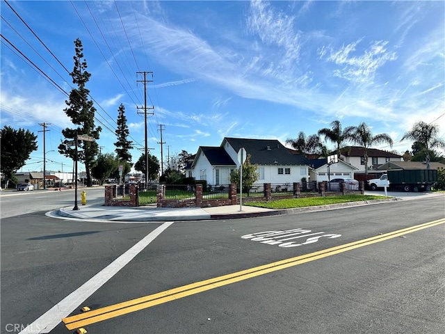 view of road with sidewalks and curbs