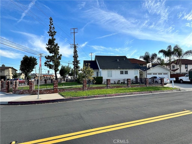 view of front of home featuring a garage, fence private yard, and a residential view
