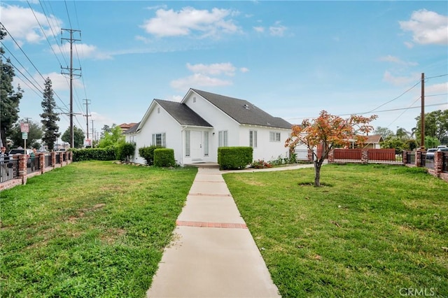 view of front of property featuring fence, a front yard, and stucco siding