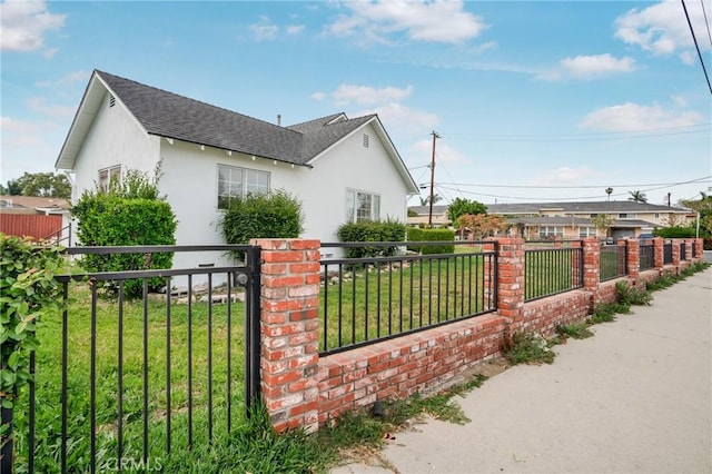 view of gate featuring fence private yard and a yard