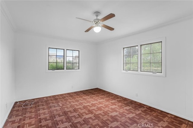 unfurnished room with ceiling fan, crown molding, and baseboards