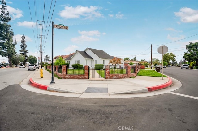 view of street with curbs, sidewalks, a residential view, and traffic signs