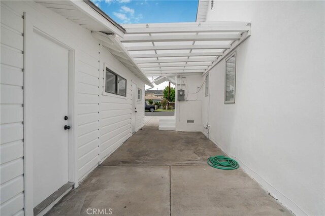 view of side of property featuring a carport and stucco siding
