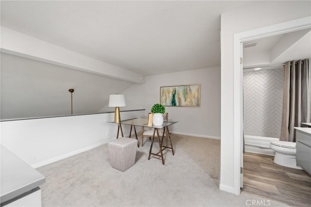 office space featuring carpet flooring, visible vents, lofted ceiling with beams, and baseboards