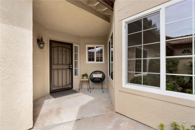 view of exterior entry with stucco siding