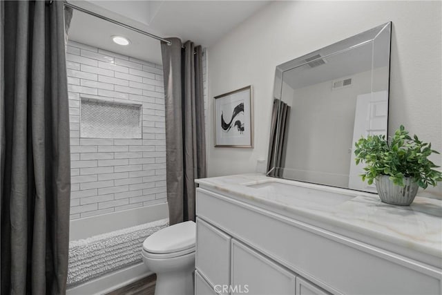 full bath featuring toilet, shower / bath combo, vanity, and visible vents